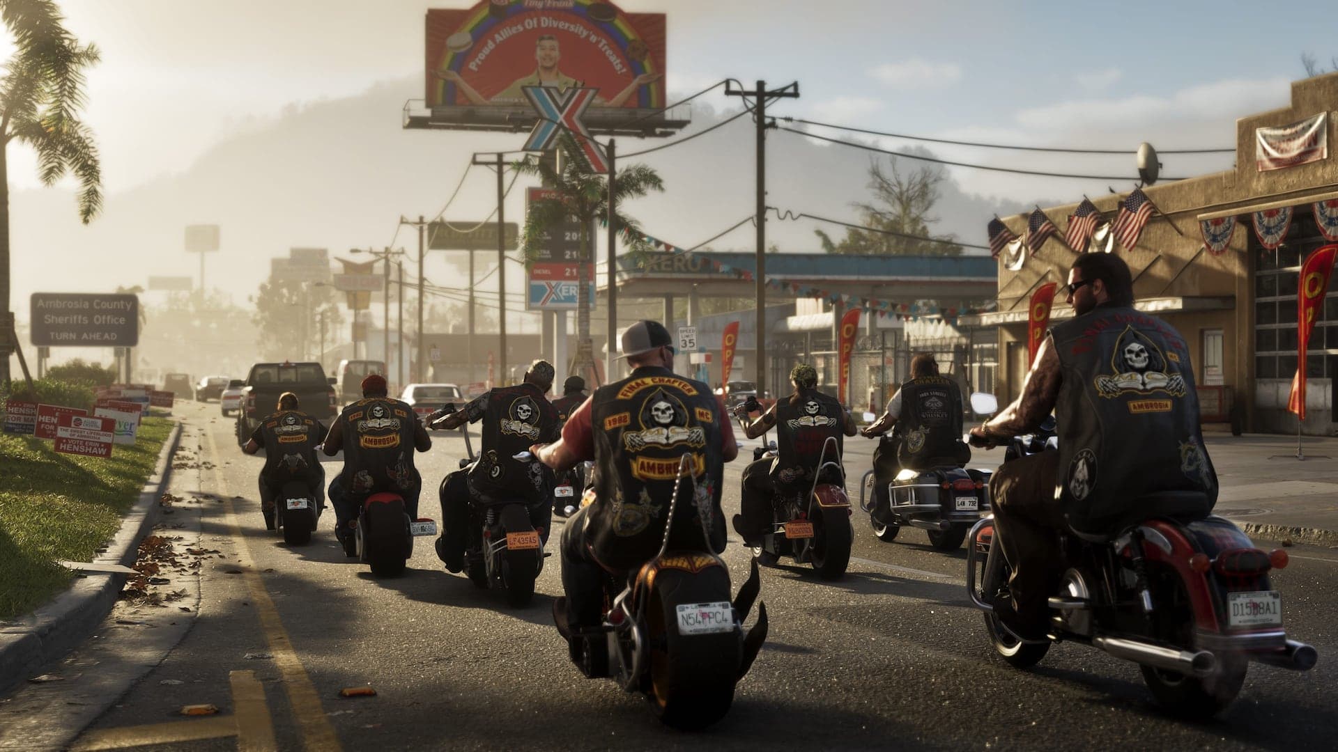 A pack of riders in matching club vests cruising down a hazy small-town main street past a gas station and billboards.