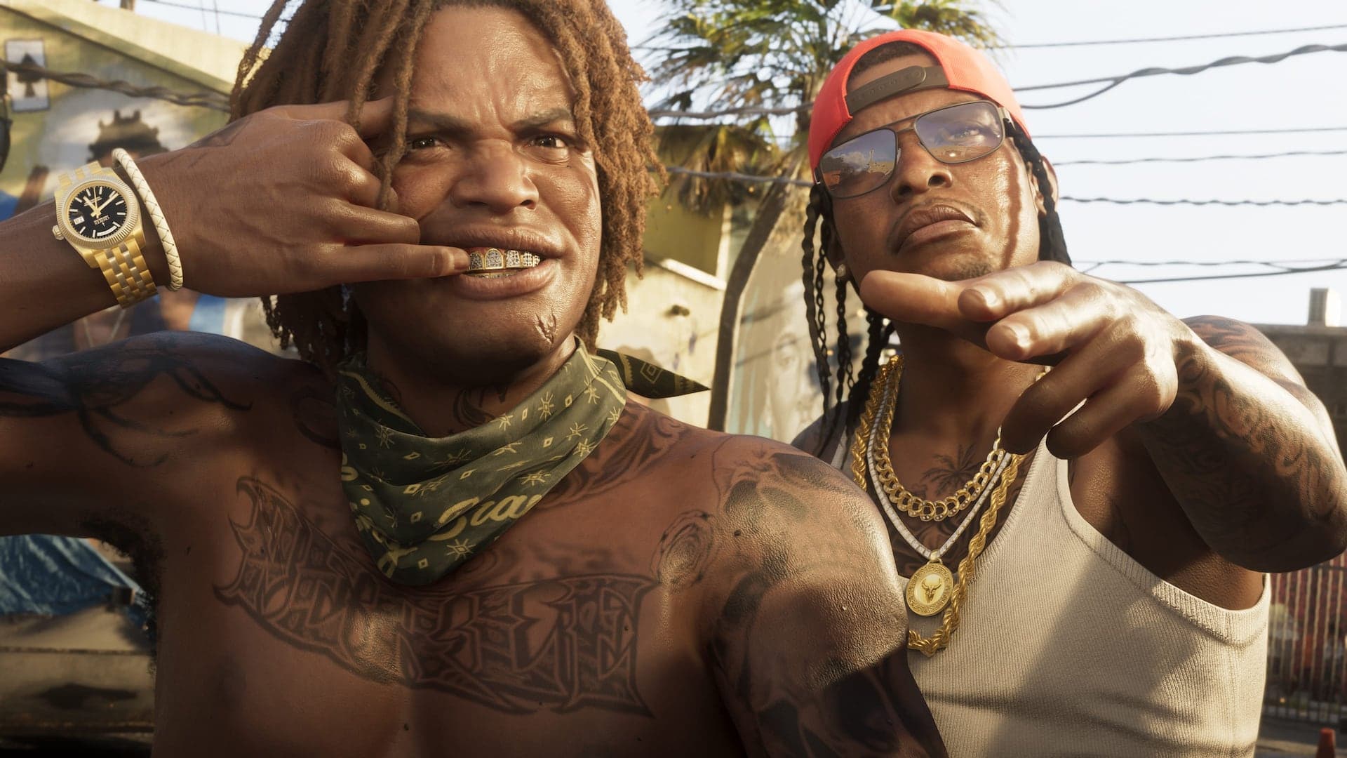 Two men posing for the camera in bright daylight, wearing gold chains and tattoos, palm trees and power lines behind them.